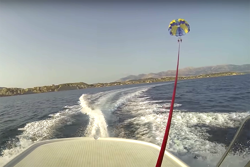 Parasailing behind a boat